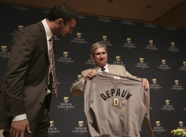 Andrew Luck receiving a DePauw sweatshirt from Bill Lynch