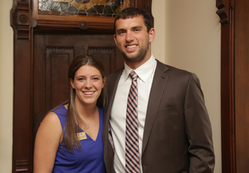 Andrew Luck posing with a student