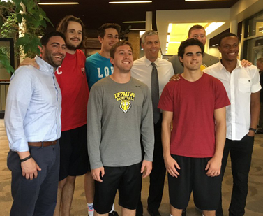 Arne Duncan with basketball players