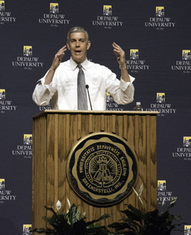 Arne Duncan behind the lecturn