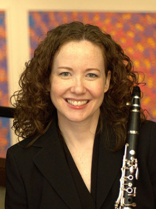 Smiling woman holding a clarinet