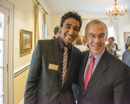 David Brooks posing with a student