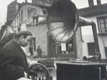 Doisneau photograph of many looking at gramophone