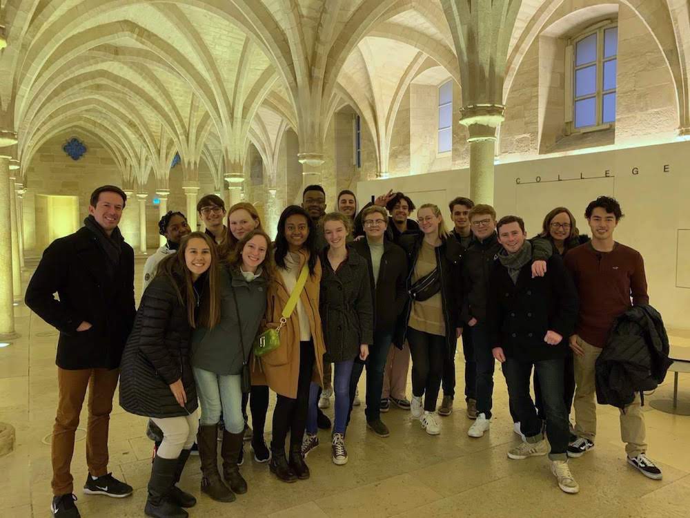 Students and faculty members take a group photo during a cultural visit in Paris.