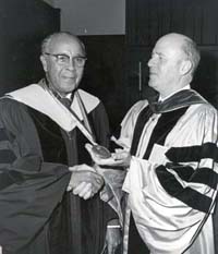 Julian shaking hands following commencement