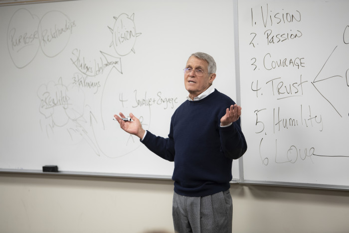 Professor Doug Smith in front of a white board
