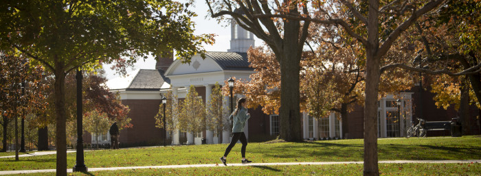 Student running on path in front of Hoover Dining Hall