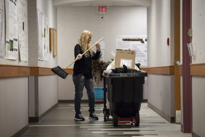 Collecting classroom trash during third shift