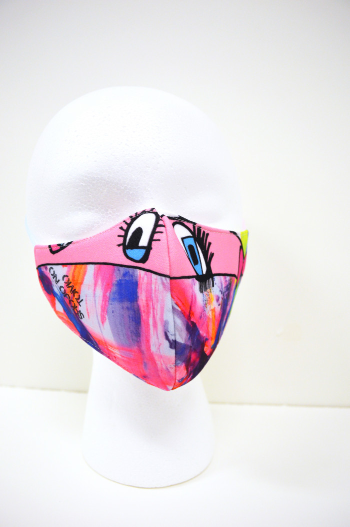 Mostly pink mask with two eyes and abstract shapes