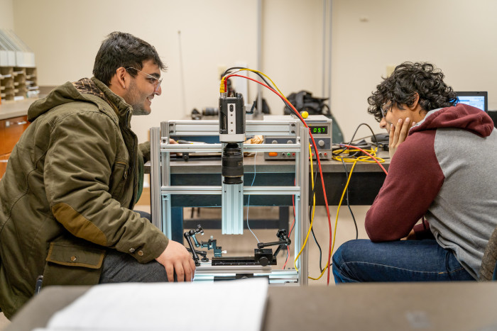 Taha Babar ‘23 and Apurv Patwardhan ‘23 record water droplets using a high-speed camera.