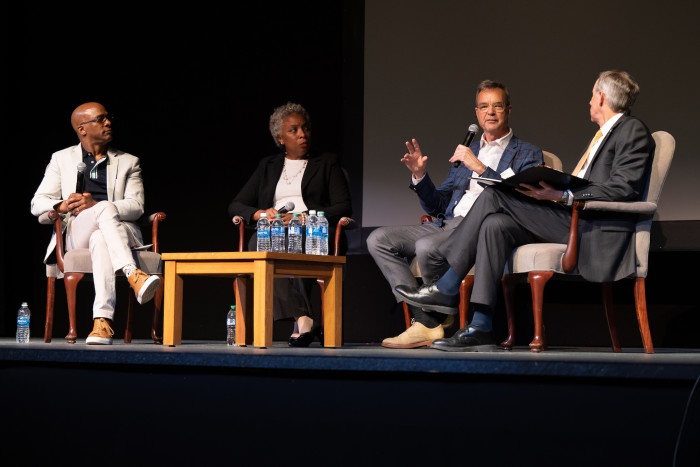 Guest speakers on stage during a lecture