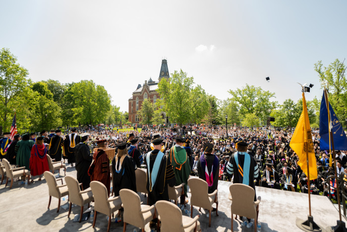 Students throw caps during commencement ceremony