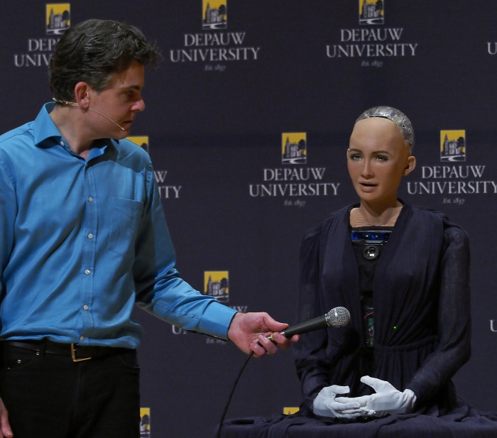 David Hanson holding a microphone for Sophia