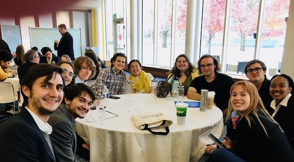 Ethics Bowl team and supporters circled around a table