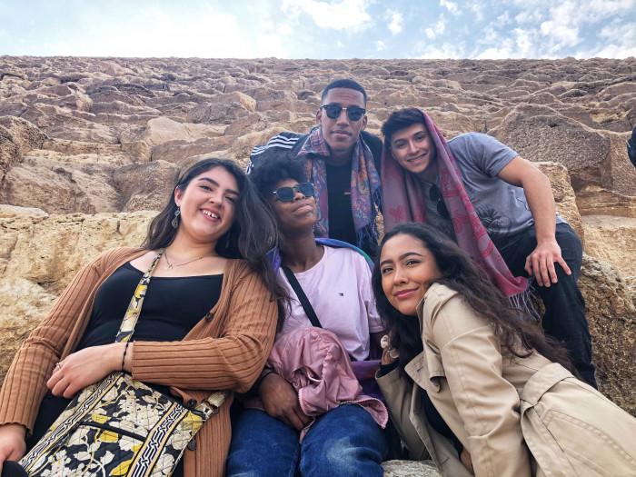 Students pose at the base of the Great Pyramid of Giza