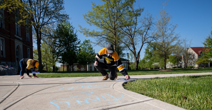 Chalking seniors' names on campus