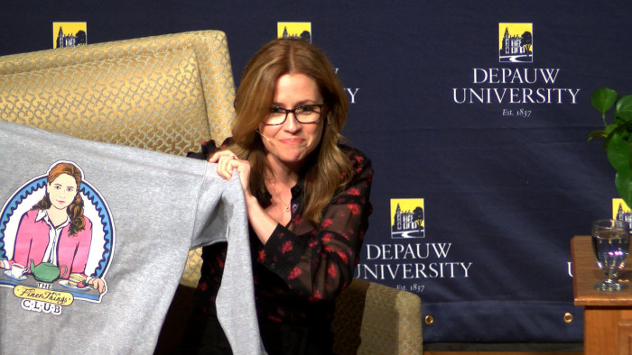 Jenna Fischer holding a Pam's Finer Things club shirt