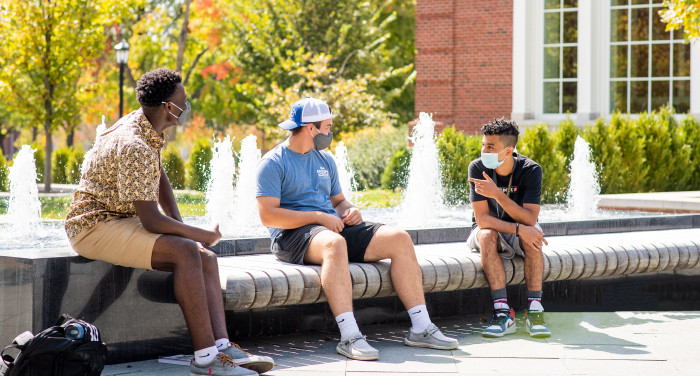 Students wear masks and socially distance