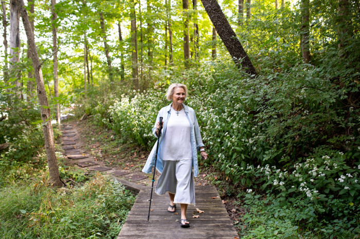 Sue Anne Starnes Gilroy walks through the woods