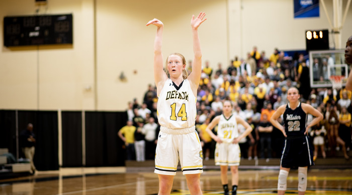 Woman shoots free throw in basketball game