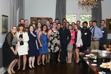 Leslie Odom Jr. posing with a large group of students at the Elm