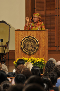 Leymah Gbowee speaking to the crowd behind a lecturn