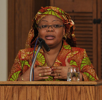 Closeup of Leymah Gbowee speaking behind a lecturn