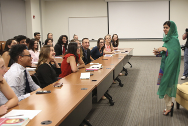 Malala Yousafzai speaking with a group of students