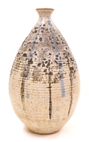 Ceramic vase by Lloyd Baker is a cream color vase with dark speckles 