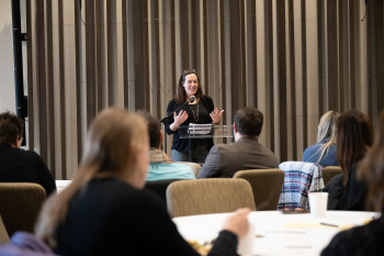 Woman standing at a podium speaking
