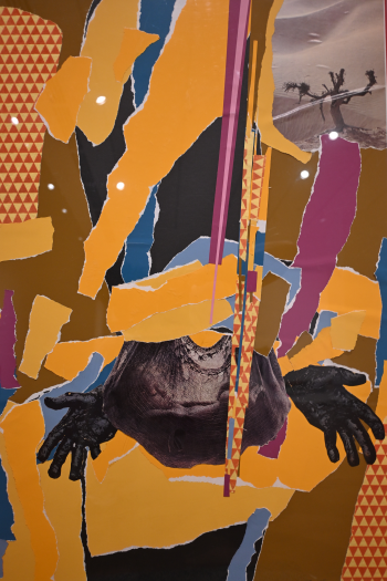 Yellow, Blue, and Burgandy ripped paper background with hands and upper right hand side has a tree in a desert