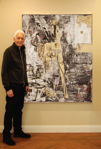 Tom Grooms standing next to a painting