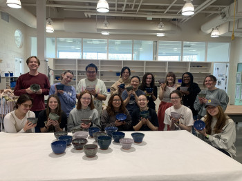 students holding ceramic bowls