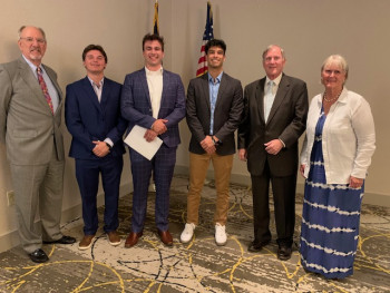 Glenn Davis, Colin Doyle, Reid Johnson, Alex Backhaus, Larry Lund, and Lindsey Lund Peterik standing together smiling