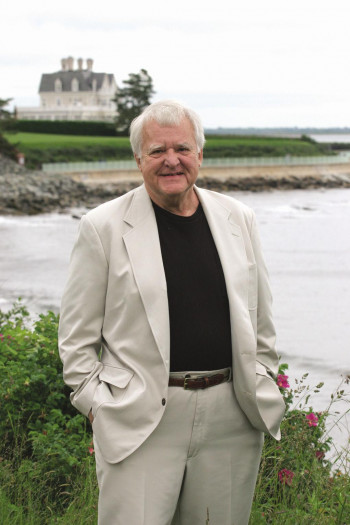 John Jakes standing with lake house background