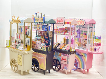 Multiple miniature carts including a disney, donuts, Barbie and Clover x Barbie 