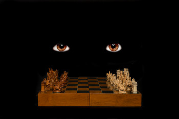 brown eyes in darkness over a chess board