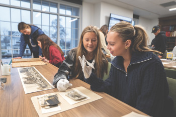 Winter term class, examining archives at Roy O West