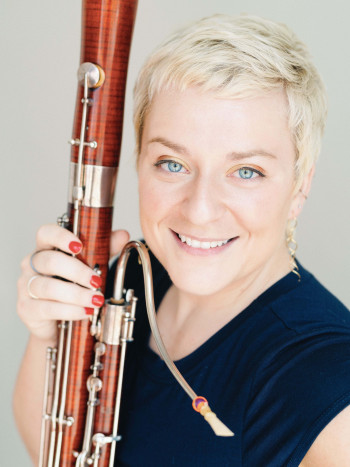 Woman smiling holding bassoon