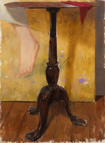 table on wooden floor with foot hanging down in front of yellow with purlple and beige shapes