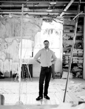 black and white photo of a male in an art studio
