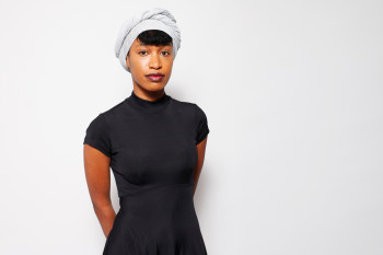 woman dressed in black with white turban on head