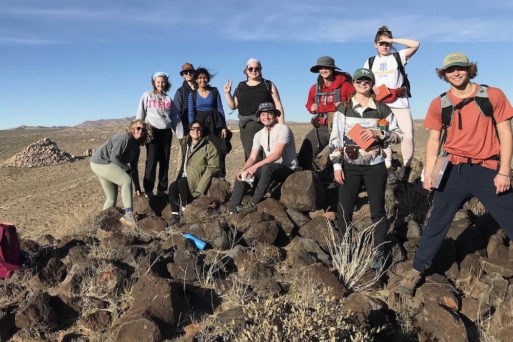 students pose for a group shot in the Mojave Desert