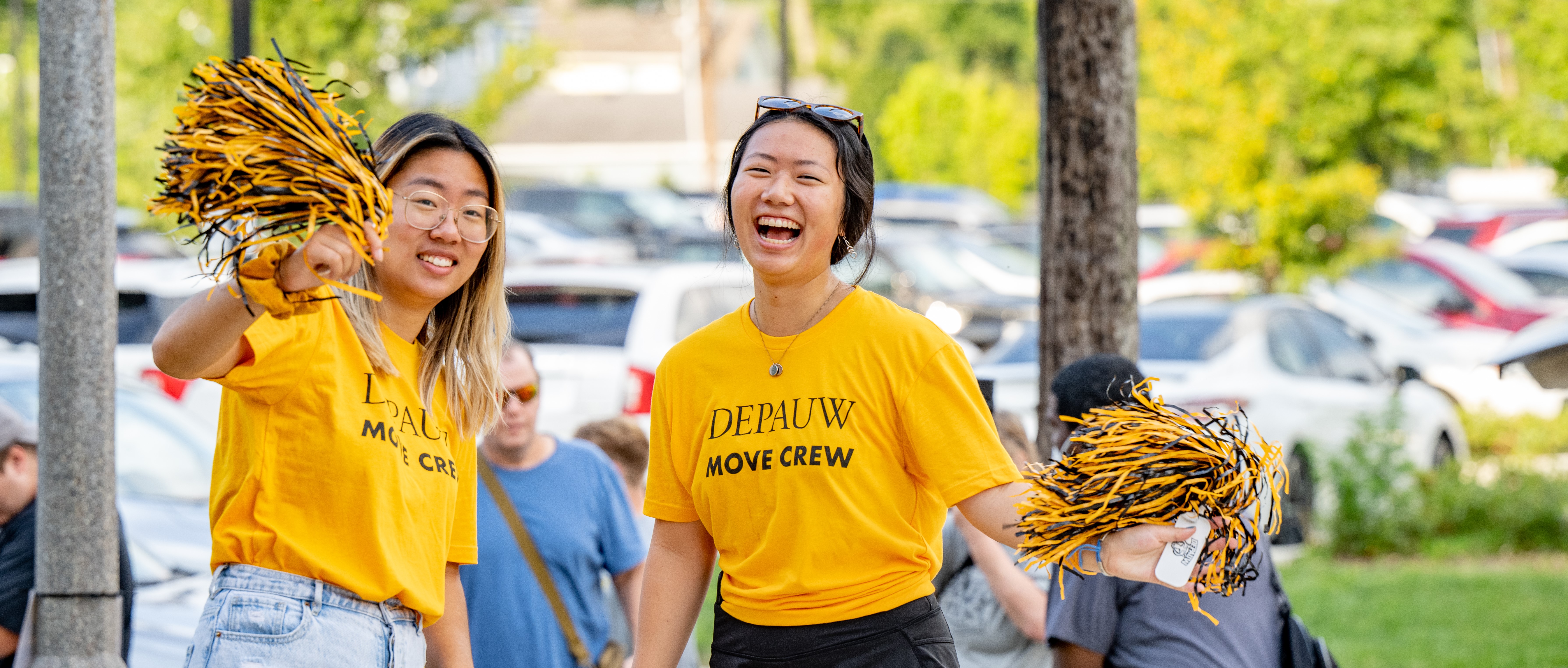 Two students smiling in Move-In Crew tshirts