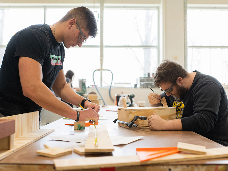two males working in woodshop