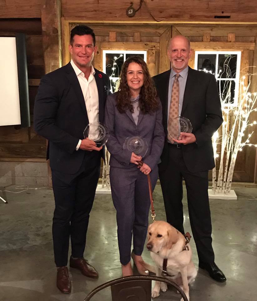 Jeffrey Harmening standing with Kristin Fleschner and Steve Weatherford