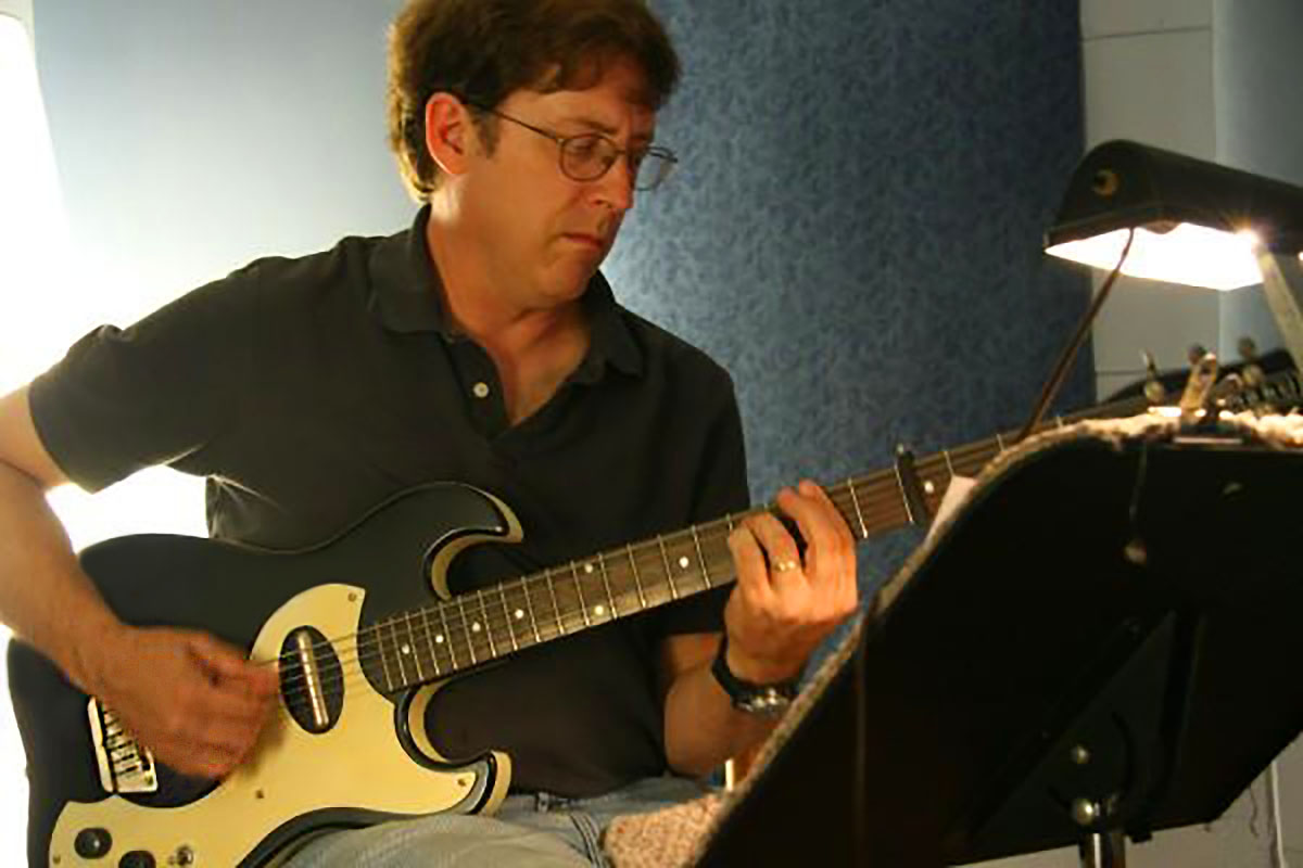 Man playing baritone guitar