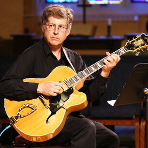 Man sitting and playing guitar