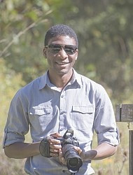 Henry Dambanemuya outside with a camera