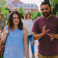 male and female walking next to each other talking